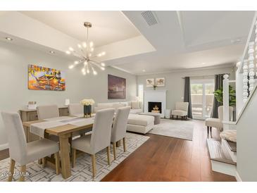 Open-concept living room with hardwood floors, fireplace, and ample natural light at 6229 N 30Th Way, Phoenix, AZ 85016