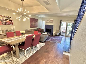 Bright open-concept living and dining area with hardwood floors and natural light at 6229 N 30Th Way, Phoenix, AZ 85016