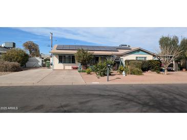 Charming home features solar panels, well-kept landscaping, and a spacious driveway at 1116 E 11Th E St, Casa Grande, AZ 85122