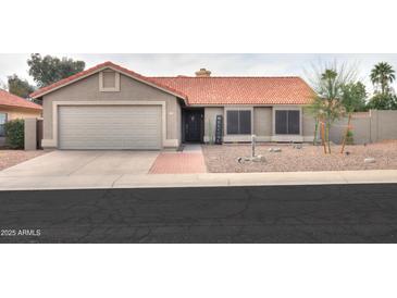 Charming single-story home with desert landscaping, a tile roof, and a two-car garage at 15018 S 28Th St, Phoenix, AZ 85048