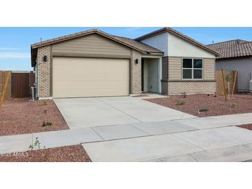 Charming single-story home featuring a two car garage and low maintenance desert landscaping at 17322 W Via Dona Rd, Surprise, AZ 85387
