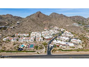 Scenic aerial view of a mountainside community boasting Southwestern architecture and desert landscaping at 3800 E Lincoln Dr # 7, Phoenix, AZ 85018