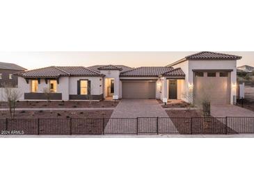Charming home with a well-manicured front yard and a two-car garage at 43720 N Acadia Way, New River, AZ 85087