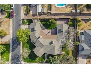 Bird's-eye view of a home featuring a circular driveway, lush landscaping, mature trees, and a well-maintained lawn at 801 W Tyson St, Chandler, AZ 85225