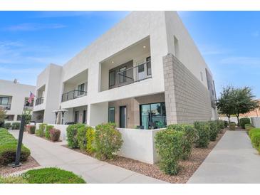 Modern two-story home featuring stucco and stacked stone facade with private balconies and manicured landscaping at 1111 E Missouri Ave # 9, Phoenix, AZ 85014