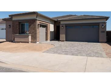 Beautiful single Gathering home featuring a brick exterior and a two-car garage at 1254 E Penedes Dr, Gilbert, AZ 85298