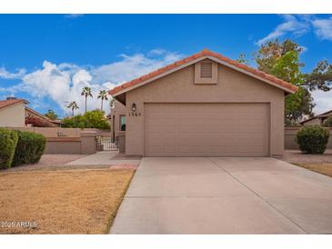 Charming single-story home featuring a two-car garage, desert landscaping, and a terracotta-tiled roof at 1365 N El Dorado Dr, Chandler, AZ 85224