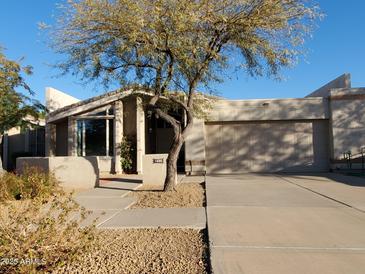 Charming single-story home with desert landscaping and a two-car garage at 1606 E Cactus Wren Dr, Phoenix, AZ 85020