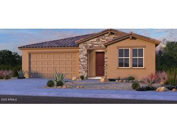 Charming single-story home featuring a stone facade, two-car garage, and manicured landscaping at 17067 W Shangri La Rd, Surprise, AZ 85388
