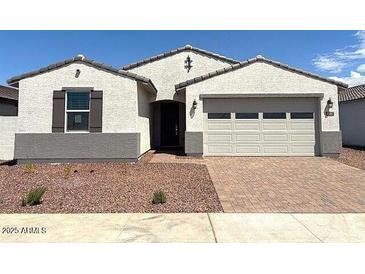 Charming single-story home with a well-manicured front yard and a two-car garage at 24578 W Grenadine Rd, Buckeye, AZ 85326