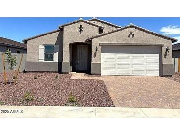 Charming single-story home with a two-car garage and desert landscaping at 24598 W Grenadine Rd, Buckeye, AZ 85326
