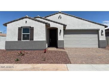 Charming single-story home with a two-car garage and a well-maintained, low-water landscape at 24612 W Grenadine Rd, Buckeye, AZ 85326