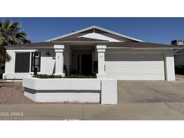 Charming single-story home with a well-maintained front yard and a two-car garage at 518 W Beverly Ln, Phoenix, AZ 85023