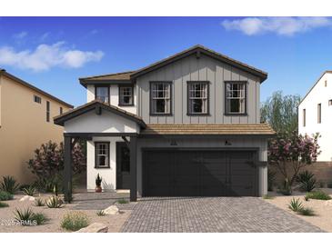 Charming two-story home featuring modern farmhouse design, two car garage, and inviting front porch at 7976 W Griswold Rd, Peoria, AZ 85345
