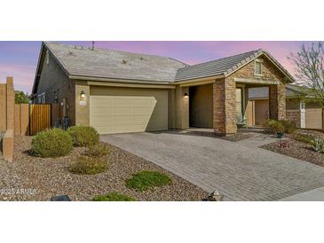 Charming single-story home with a two-car garage and a beautifully paved driveway complemented by desert landscaping at 13218 W Crimson Ter, Peoria, AZ 85383