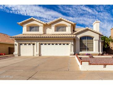 Inviting two-story home with a three-car garage and well-maintained landscaping in a suburban neighborhood at 1478 E Spur Ave, Gilbert, AZ 85296
