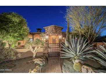 Beautiful desert landscaping surrounds this home with mature trees and gated entry in Scottsdale, Arizona at 15123 E Monument Rd, Scottsdale, AZ 85262