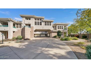 Stunning multi-story home with stucco exterior, concrete driveway, and well-maintained landscaping at 15221 N Clubgate Dr # 2094, Scottsdale, AZ 85254
