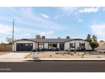 Charming single-story home featuring a well-maintained front yard and a two car garage at 3141 E Hillery Dr, Phoenix, AZ 85032