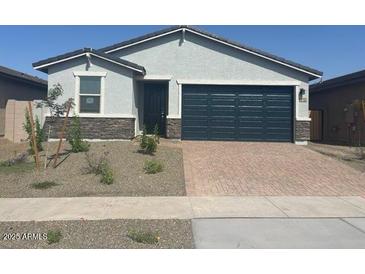 Charming single-story home with a two-car garage and desert landscaping in front at 3732 S 87Th Dr, Tolleson, AZ 85353