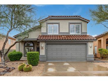 Charming two-story home with a tile roof, desert landscaping, and a two-car garage at 4514 E Coyote Wash Dr, Cave Creek, AZ 85331