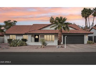 Charming single-story home features a desert landscaped front yard, tile roof, and attached two-car garage at 5850 E Le Marche Ave, Scottsdale, AZ 85254