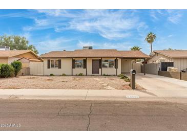 Single-story home with desert landscaping, covered carport and cozy charm at 6031 W Hearn Rd, Glendale, AZ 85306