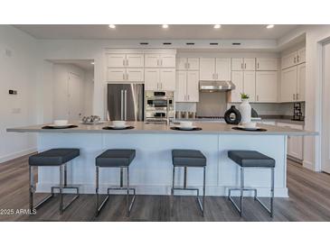 Beautiful modern kitchen with stainless steel appliances, a large island, and white cabinetry at 11673 N 136Th St # 1013, Scottsdale, AZ 85259