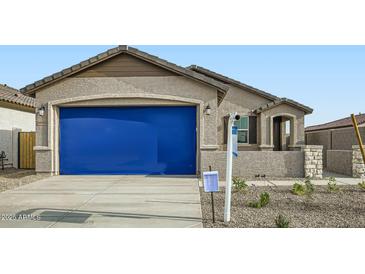 Cozy single-story home with a two-car garage featuring desert landscaping and a welcoming front porch at 14968 W Hackamore Dr, Surprise, AZ 85387