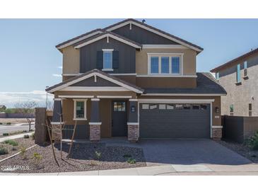 Charming two-story home with a two-car garage and attractive desert landscaping at 16213 W Soft Wind Dr, Surprise, AZ 85387