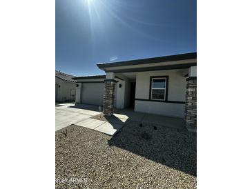 Charming single-story home featuring a two-car garage, stone accents, and low-maintenance landscaping at 18231 W Paraiso Dr, Surprise, AZ 85387