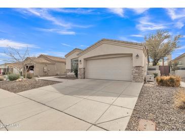 Charming single-story home featuring a two-car garage, stone accents, and a well-maintained desert landscape at 2213 E Constance Way, Phoenix, AZ 85042