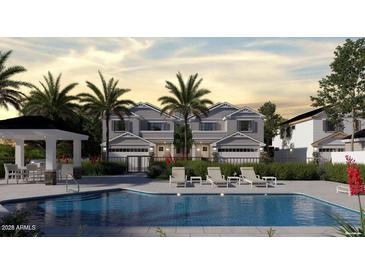 Stunning community pool area with lounge chairs, palm trees, and a gazebo for relaxing at 2604 N 27Th St # 4, Phoenix, AZ 85008
