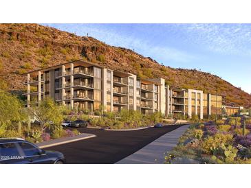 Modern condo building with desert landscaping nestled against a scenic mountain backdrop at 5000 N Camelback Ridge Dr # 203, Scottsdale, AZ 85251