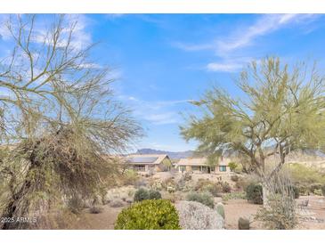 Desert home features desert landscaping, a backyard patio, and mountain views at 8096 E Lavender Dr, Gold Canyon, AZ 85118