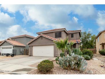 Charming two-story home featuring desert landscaping and a spacious two-car garage at 1135 E Desert Holly Dr, San Tan Valley, AZ 85143