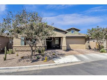 Charming single-Gathering home with a two-car garage, desert landscaping, and a covered entryway at 1432 E Pedro Rd, Phoenix, AZ 85042