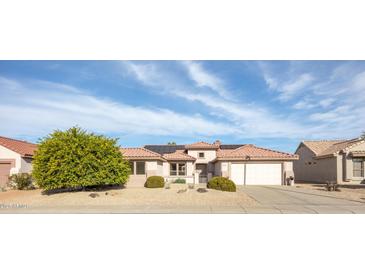 Charming single-story home featuring a red tile roof, desert landscaping, and a two-car garage at 15864 W Clearwater Way, Surprise, AZ 85374
