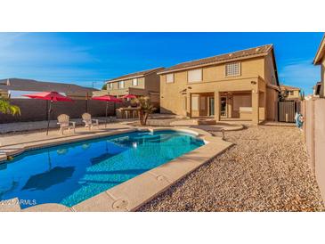 Enjoy a refreshing dip in this backyard pool, surrounded by a patio, ideal for outdoor relaxation and entertaining at 22157 W Moonlight Path, Buckeye, AZ 85326