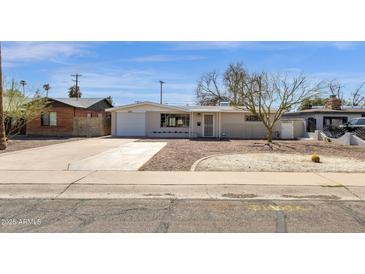Charming single-story home with a well-maintained front yard and a long driveway at 2545 E Amelia Ave, Phoenix, AZ 85016