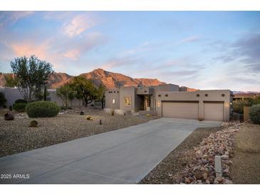 Beautiful desert home with a long driveway, two-car garage and mountain views at 4845 S Strike-It-Rich Dr, Gold Canyon, AZ 85118