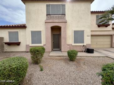Two-story home featuring a desert landscape, tan stucco, and a red tiled roof at 671 E Colt Ct, Chandler, AZ 85225