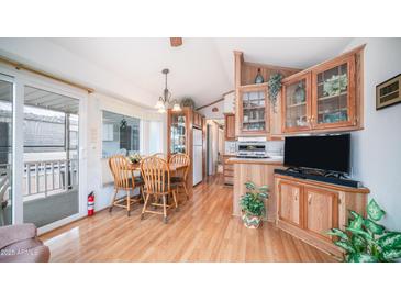 Inviting kitchen with wood floors, dining area, and glass door to the exterior patio at 711 Felspar Dr, Apache Junction, AZ 85119