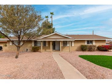 Charming single-story home featuring a brick facade and manicured desert landscaping and walkway at 1226 E Fairmont Dr, Tempe, AZ 85282