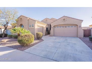 Charming home featuring a three-car garage, desert landscaping, and a well-maintained exterior at 15993 W Poinsettia Dr, Surprise, AZ 85379