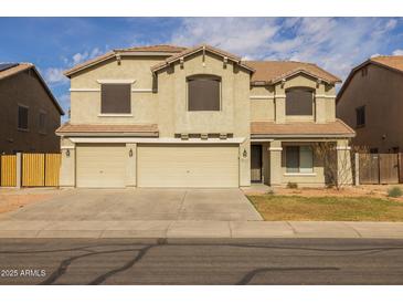 Inviting two-story home featuring a three-car garage and neutral stucco exterior at 43646 W Elizabeth Ave, Maricopa, AZ 85138