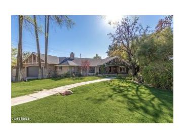 Charming single-story home with well-manicured lawn and mature trees at 5112 N 41St St, Phoenix, AZ 85018
