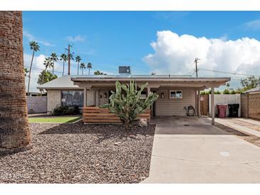 Charming single-story home with a desert landscape, covered carport, and inviting curb appeal at 6943 E Granada Rd, Scottsdale, AZ 85257
