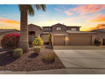 Stunning two-story home featuring a three-car garage, desert landscaping, and a private entrance at 8761 W Mary Ann Dr, Peoria, AZ 85382