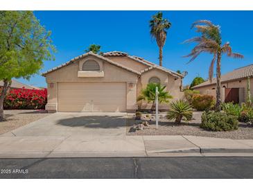 Charming home featuring a two-car garage, desert landscaping, and neutral color palette at 9922 E Onza Ave, Mesa, AZ 85212